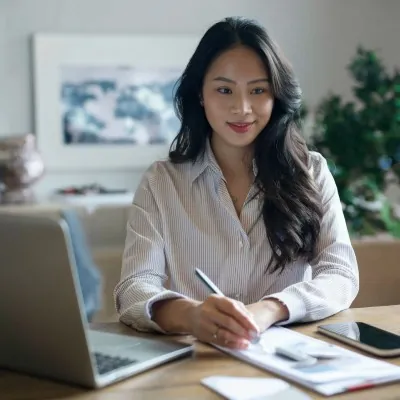 Real estate virtual assistant taking notes at her laptop